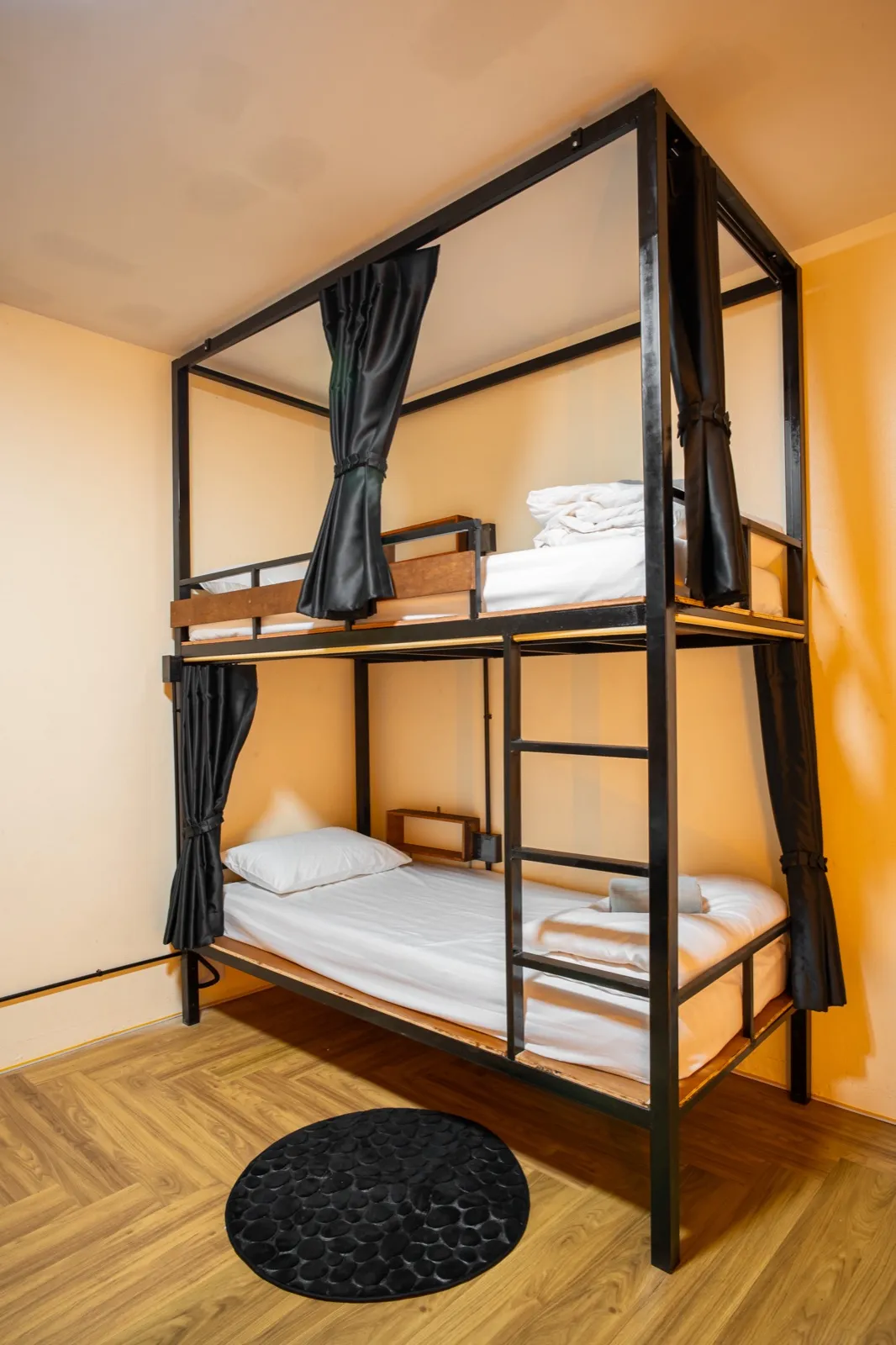 Cosy dorm bunk with warm lighting at the cannabis-friendly hostel in Ao Nang