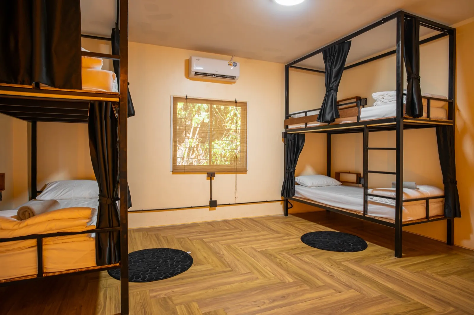 Bright air-conditioned dorm room with a window at The Hub Laidback Hostel, Krabi
